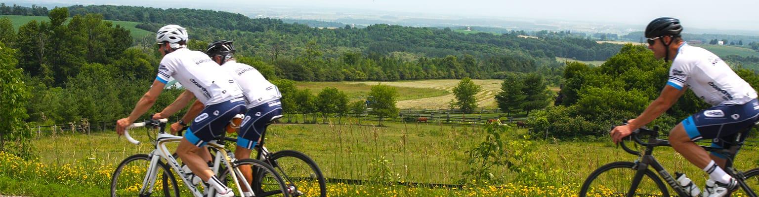 three cyclists on a country road